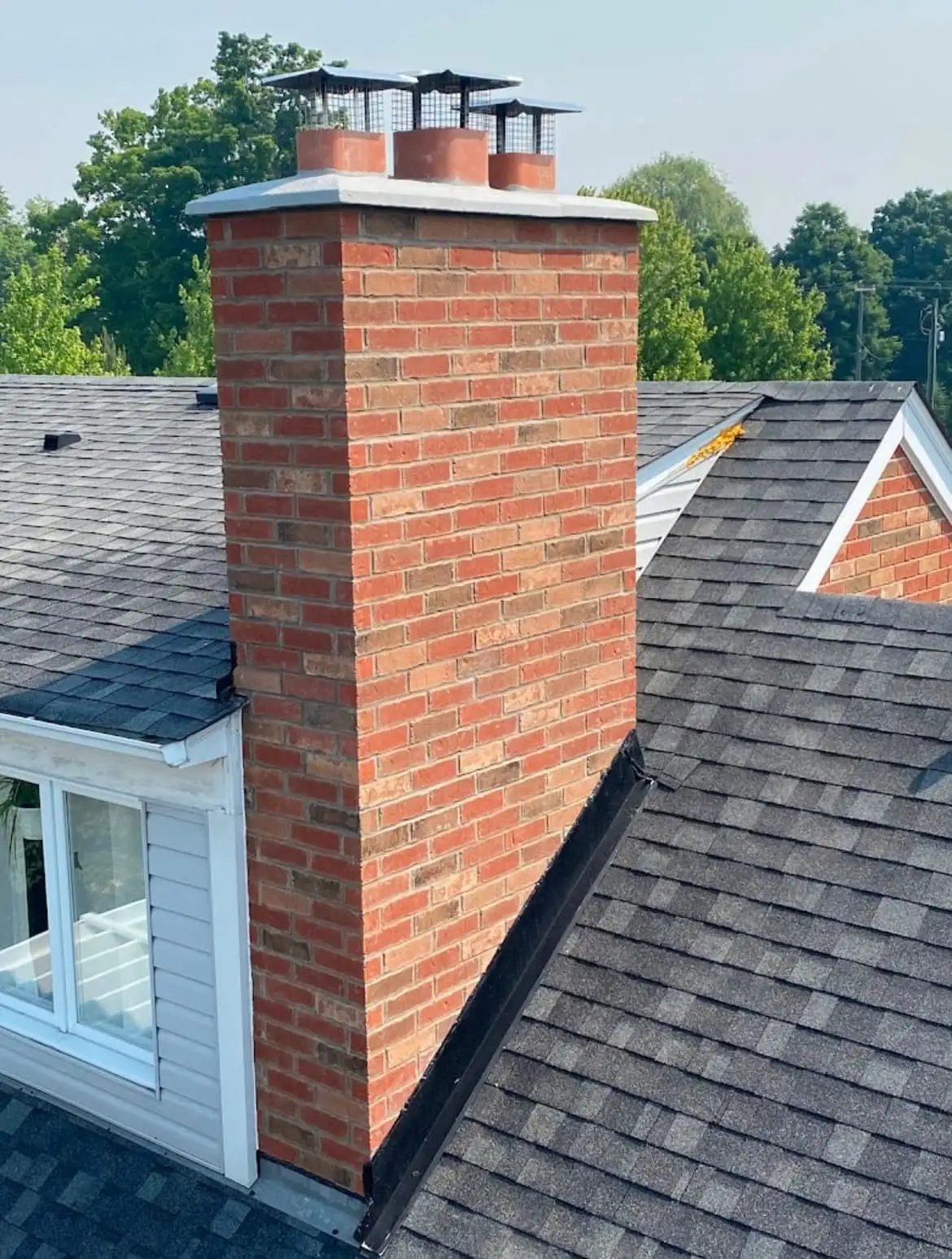 Rebuilt brick chimney with three flue caps, Putnam County, NY